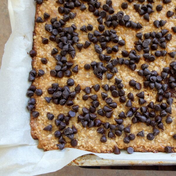 A pan with baked Oat\'s n Toffee topped with chocolate chips