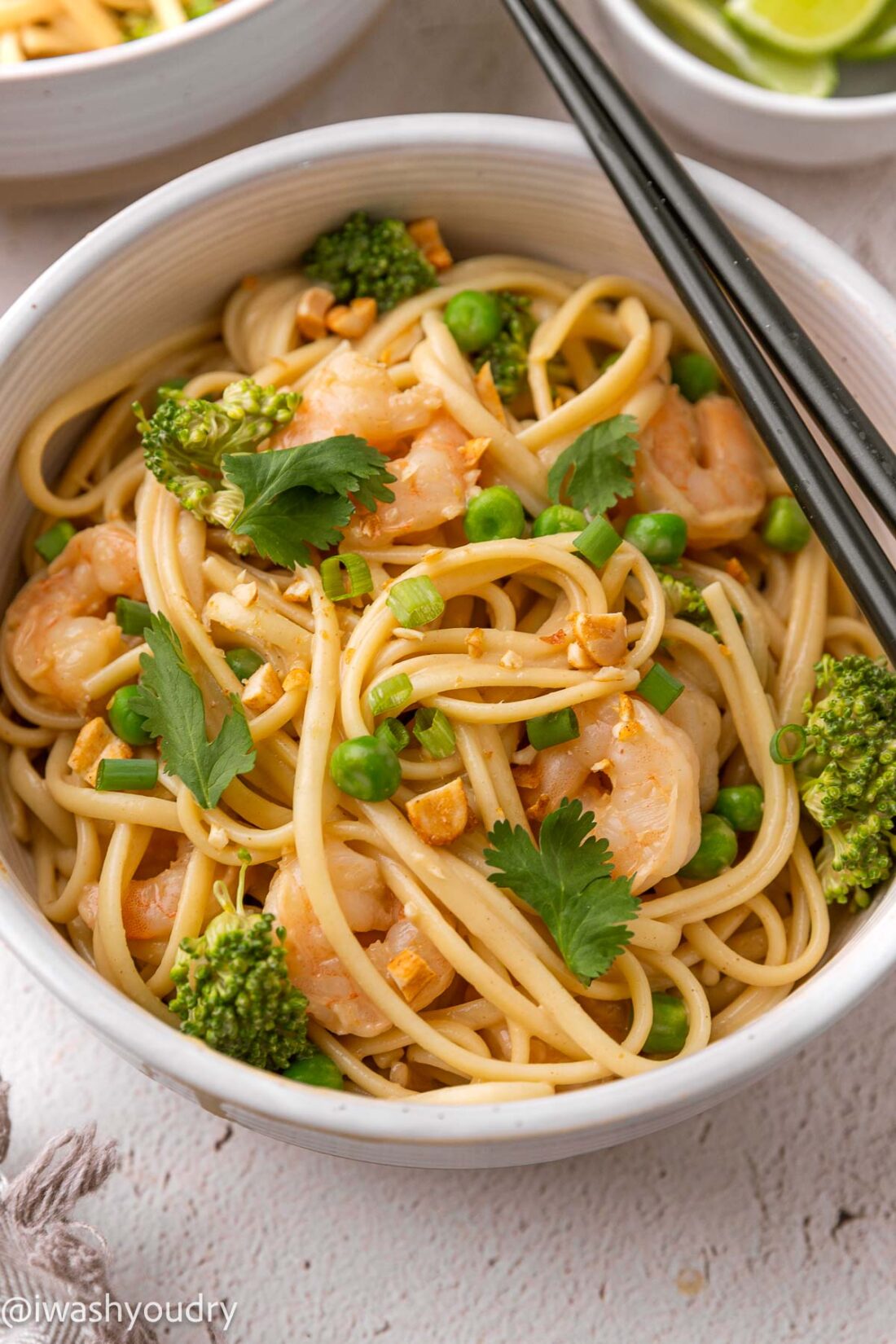 white bowl with noodles and shrimp.