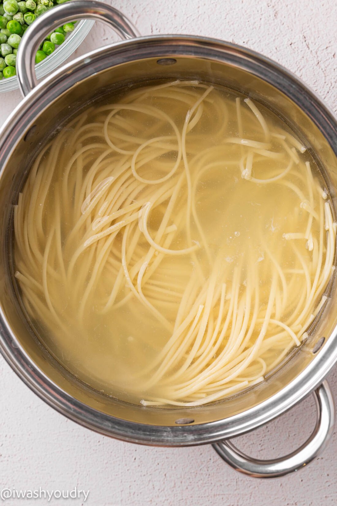 boiling water with noodles inside pot.