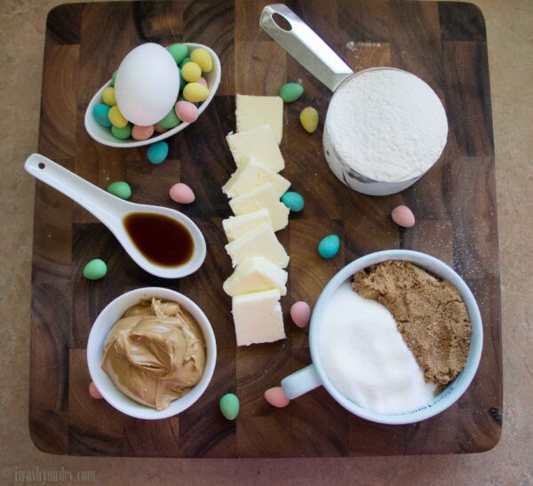 A display of ingredients needed in measuring cups for Peanut Butter and Chocolate Egg Blondies