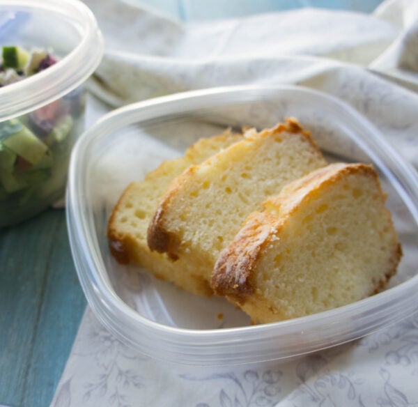 A plastic container with 3 slices of cake