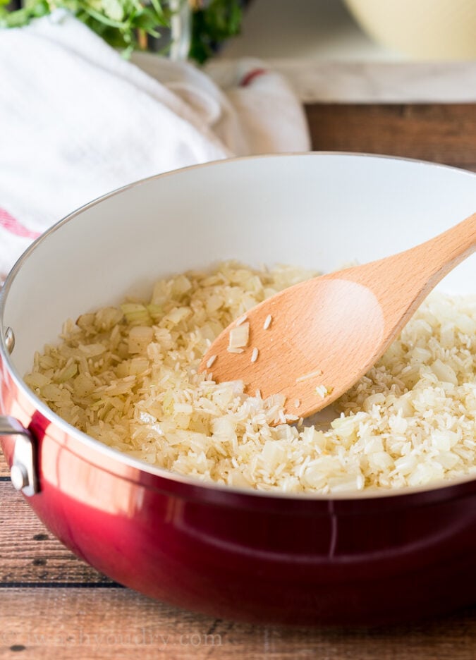 Start by toasting your Mexican Rice with ground cumin and garlic salt in a hot skillet.