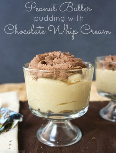 A clear glass dessert cup with Peanut Butter Pudding topped with chocolate whip cream