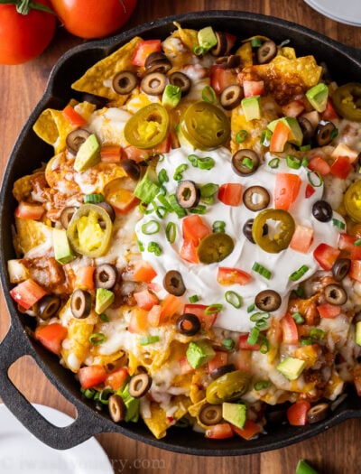 plate of crispy, cheesy nachos with toppings