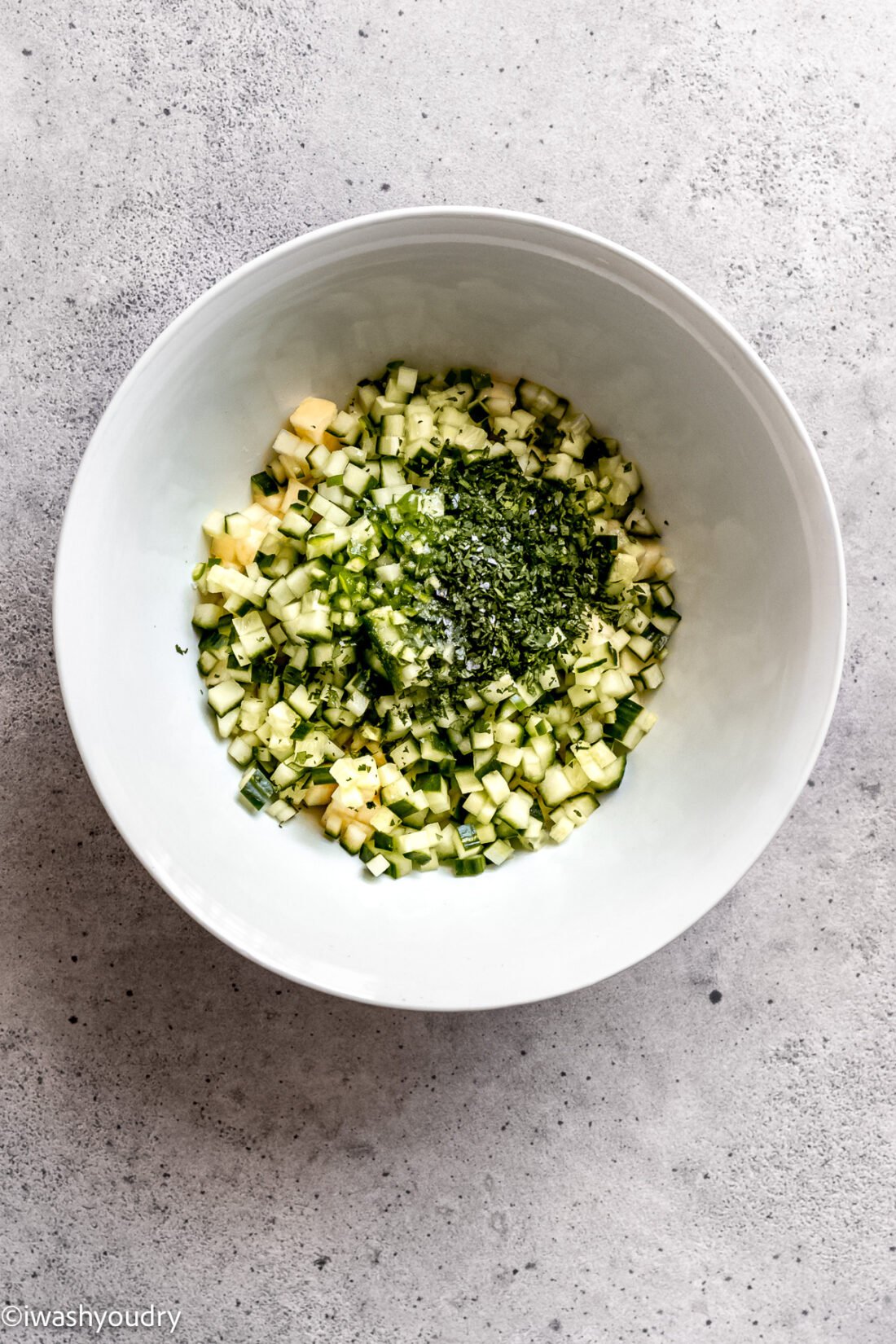 Cilantro, pineapple, and cucumber in bowl. 