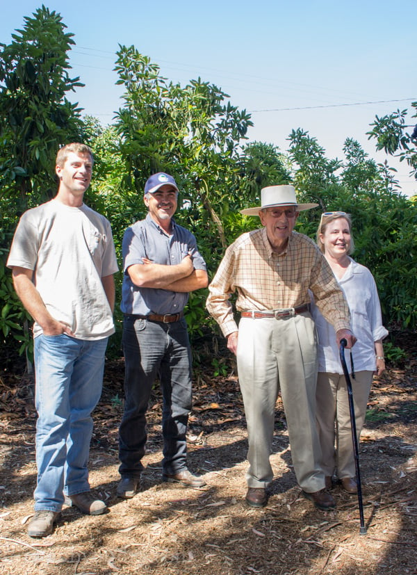 A group of people surrounded by trees
