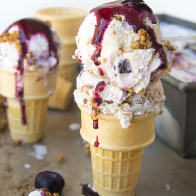 scoops of blueberry ice cream in cones.