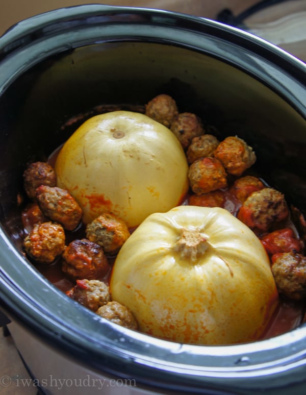 spaghetti squash inside of crock pot/slow cooker with meatballs.