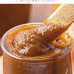 Cooked pumpkin butter in a jar with a spoon,