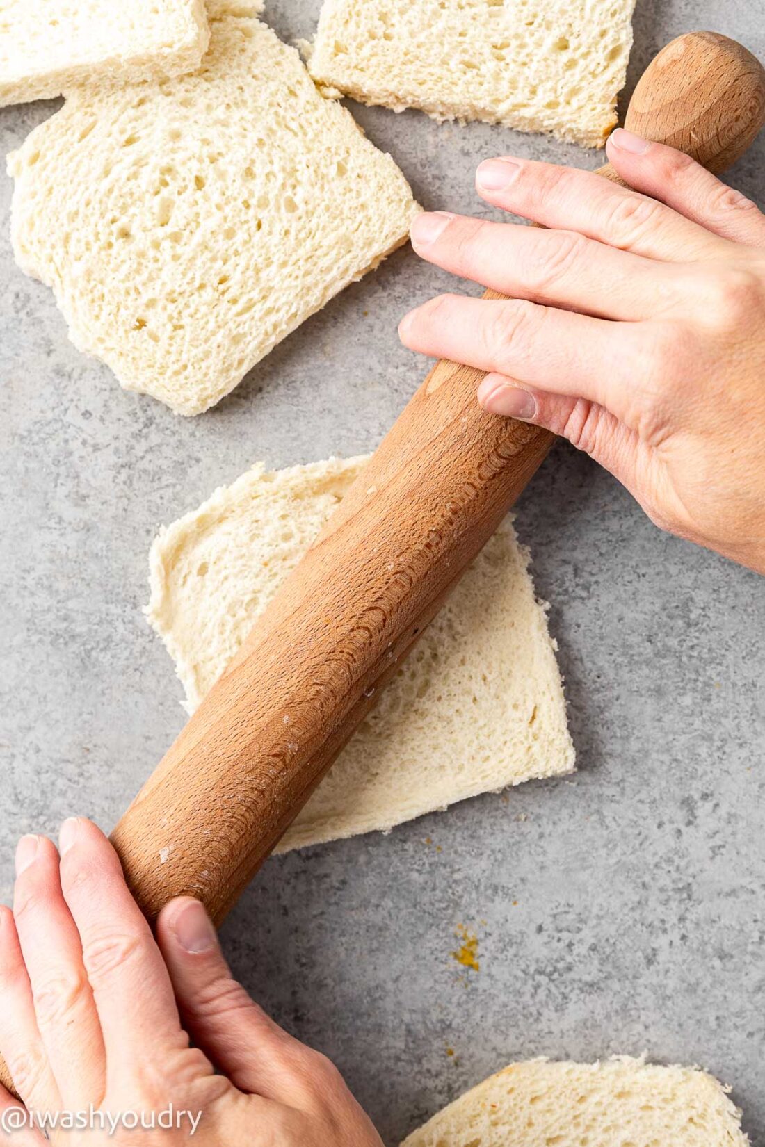 flattening bread with rolling pin.