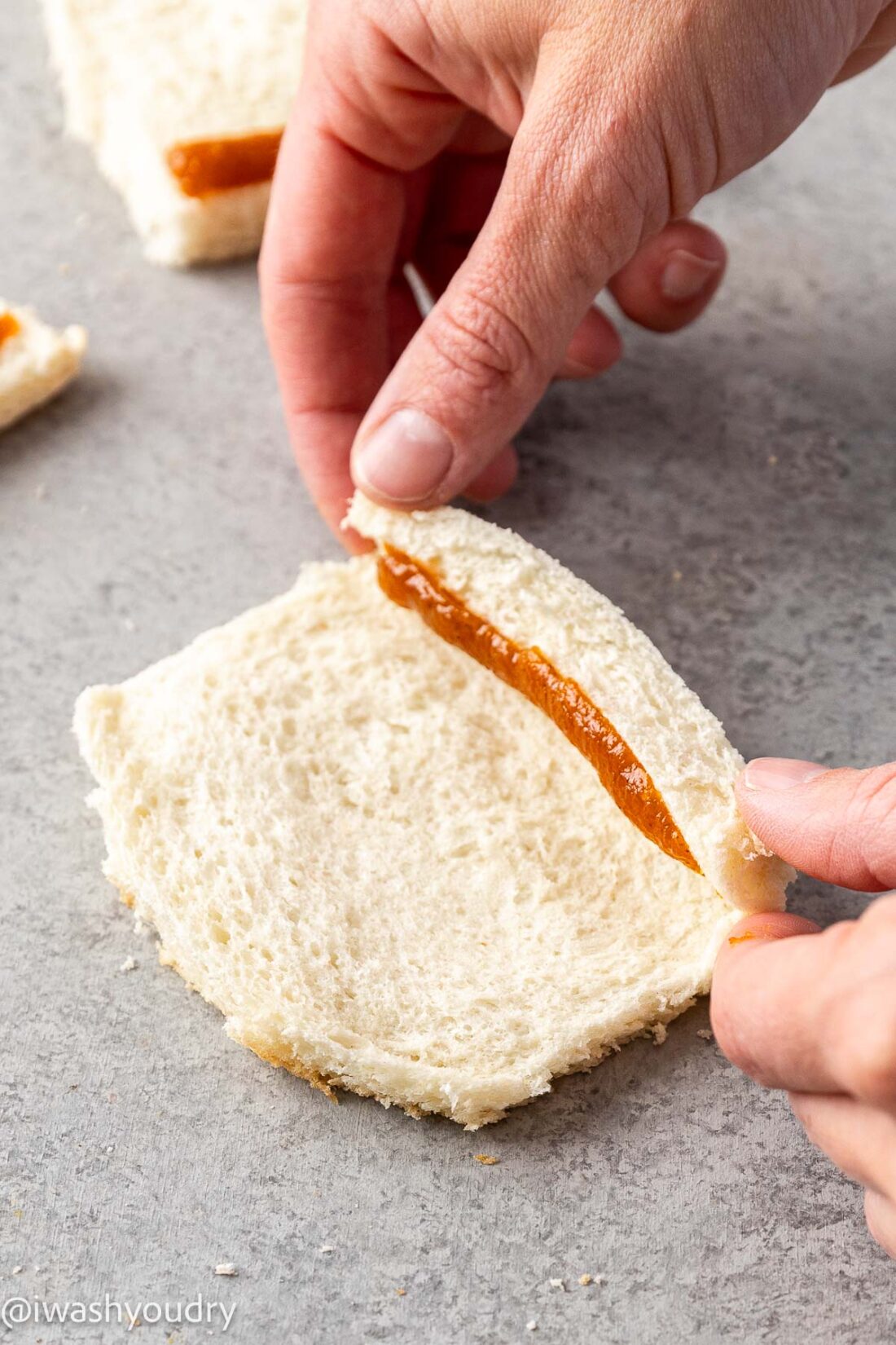 Rolling pumpkin filling into the middle of white bread.