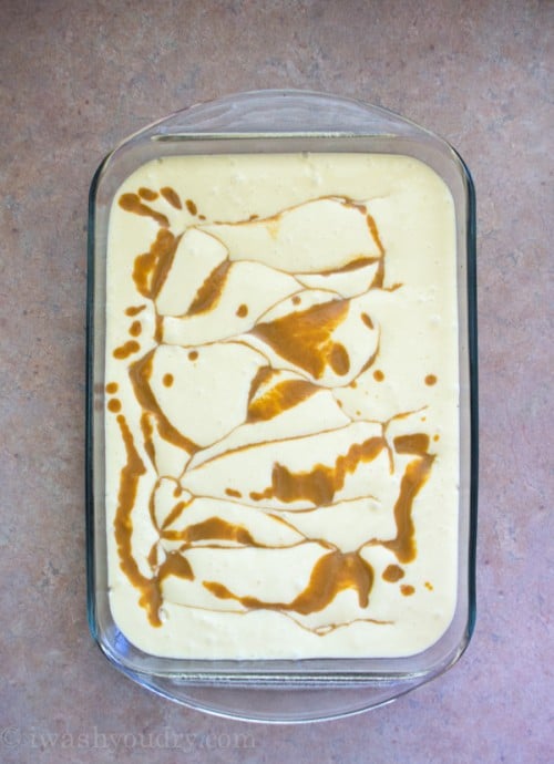 A look down on the top of Pumpkin Magic Cake batter in a glass pan