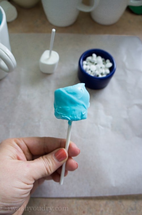 A close up of a blue frosted marshmallow pop