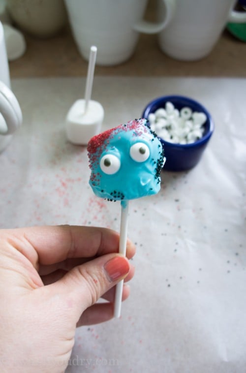 A close up of a Blue covered marshmallow pop monster