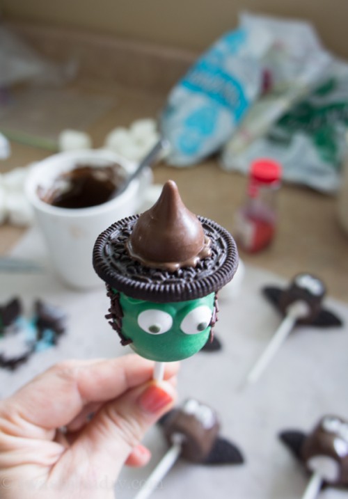 A close up of a marshmallow pop made to look like a witch
