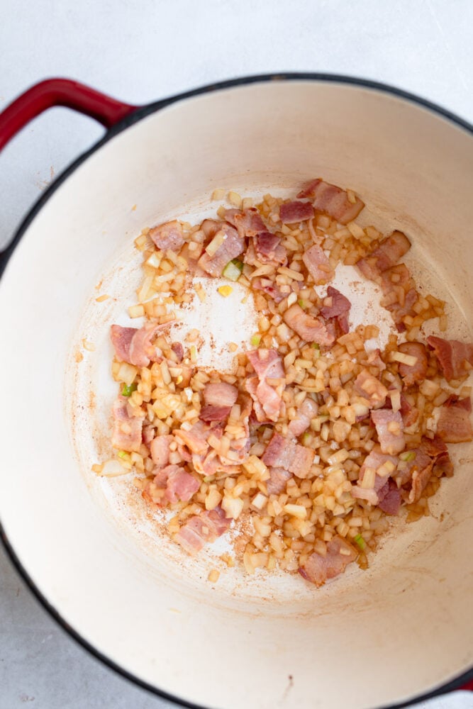 cooking bacon and onions in pan