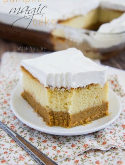 A slice of layered pumpkin cake topped with frosting titled, "Pumpkin Magic Cake"