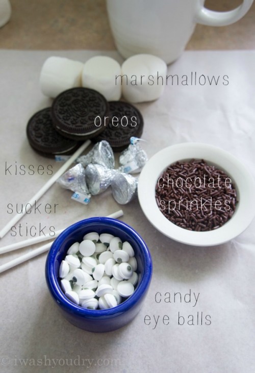 A display of ingredients needed to make marshmallow pops; large marshmallows, Oreos, chocolate kisses, chocolate sprinkles and candied eyeballs