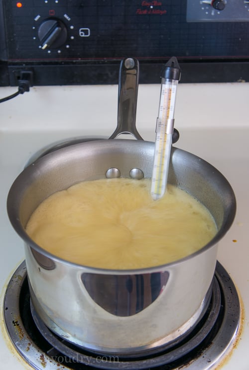 A pan of melted ingredients with a candy thermometer in it