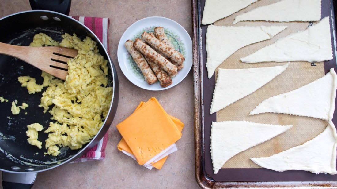 ingredients for sausage wraps on surface.