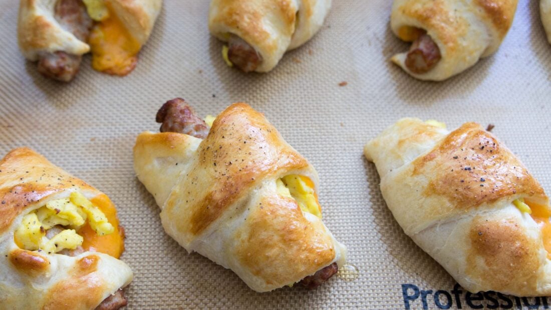 golden brown baked roll ups on baking sheet.