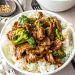 white bowl with rice and beef and broccoli sauce
