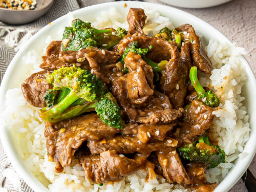 white bowl with rice and beef and broccoli sauce