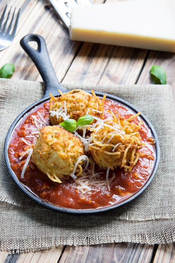 Spaghetti Balls with Meat Sauce! Spaghetti is combined with a cheesy mixture then formed into balls and fried until golden brown, then placed on top of a rich and hearty meat sauce.