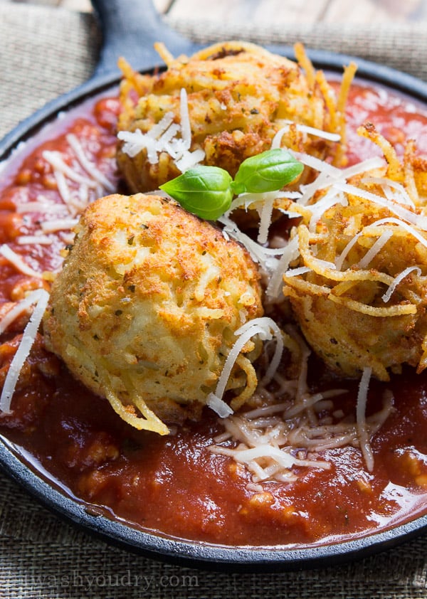 Spaghetti Balls with Meat Sauce! Spaghetti is combined with a cheesy mixture then formed into balls and fried until golden brown, then placed on top of a rich and hearty meat sauce.