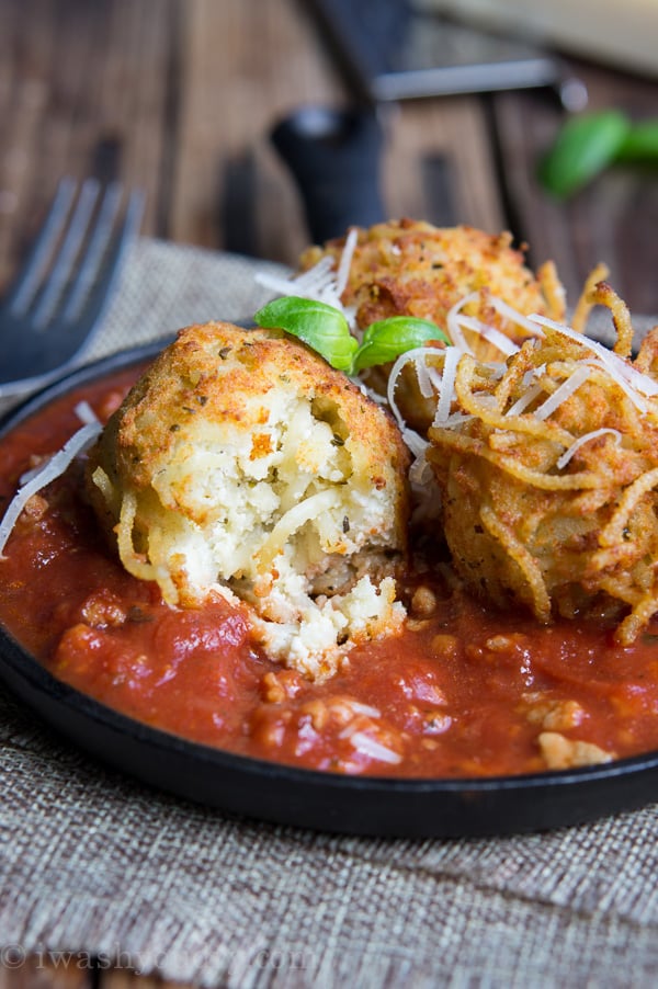 Spaghetti Balls with Meat Sauce! Spaghetti is combined with a cheesy mixture then formed into balls and fried until golden brown, then placed on top of a rich and hearty meat sauce.