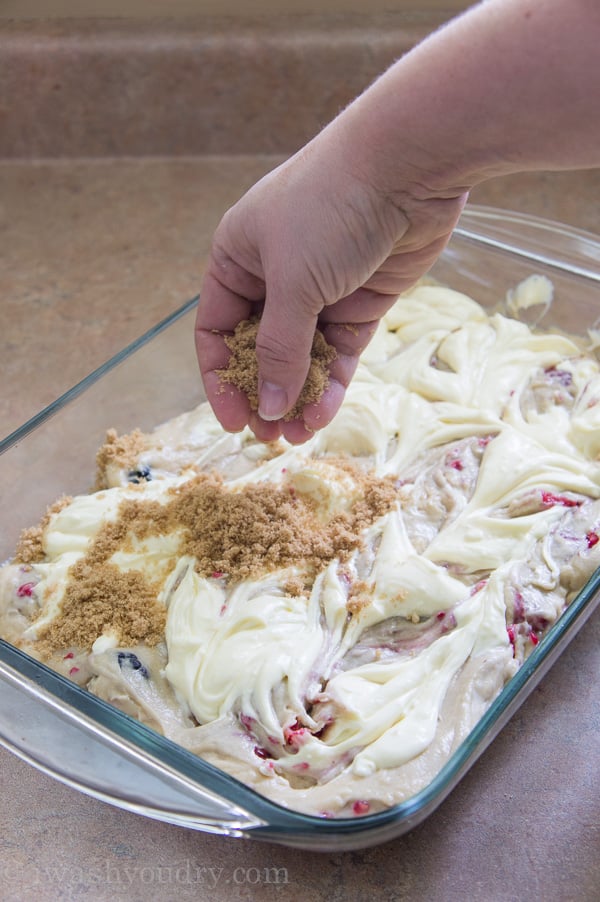 This Cheesecake Swirled Brown Sugar Cake is devilishly moist, filled with plump raspberries and blackberries, then topped with a creamy cheesecake swirl and a crisp brown sugar crumble. 