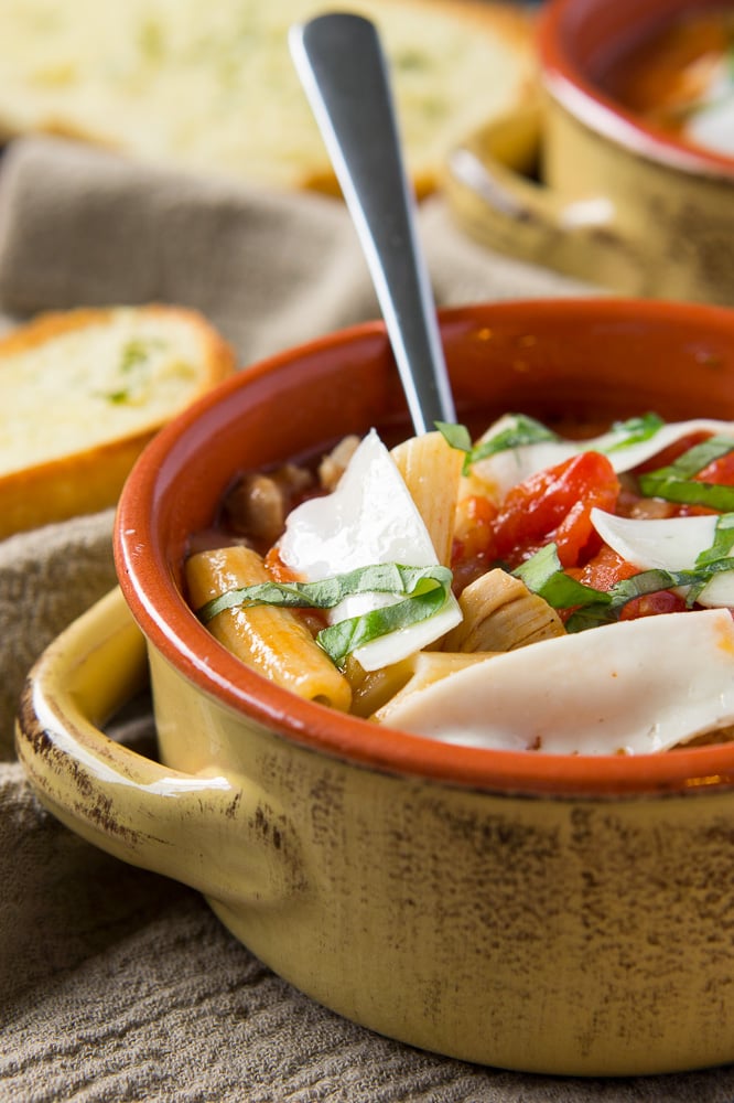 soup with tomatoes, chicken, pasta and parmesan cheese
