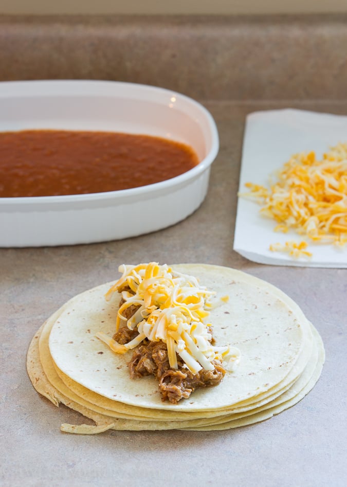 Sweet Pulled Pork Enchiladas with homemade enchilada sauce… these are to die for!! 