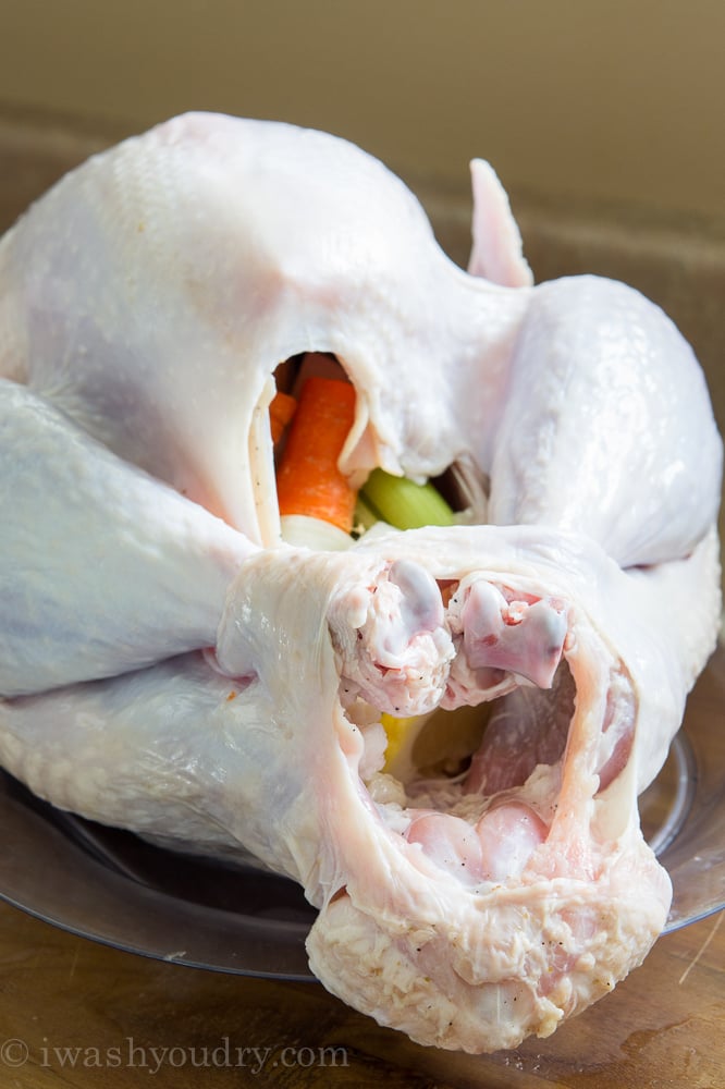 Close up of raw turkey with veggies inside