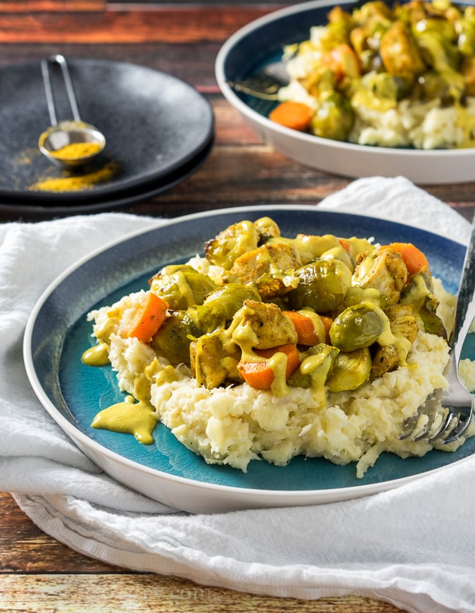 Curry Roasted Chicken and Brussel Sprouts over a creamy parsnip mash and topped with a creamy yellow curry sauce. A #lowcarb easy dinner that comes together in minutes! 