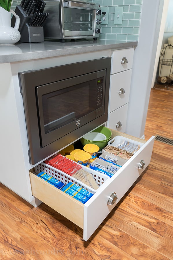 The drawer below the under mount microwave is full of kid approved snacks and meals! This is genius! 