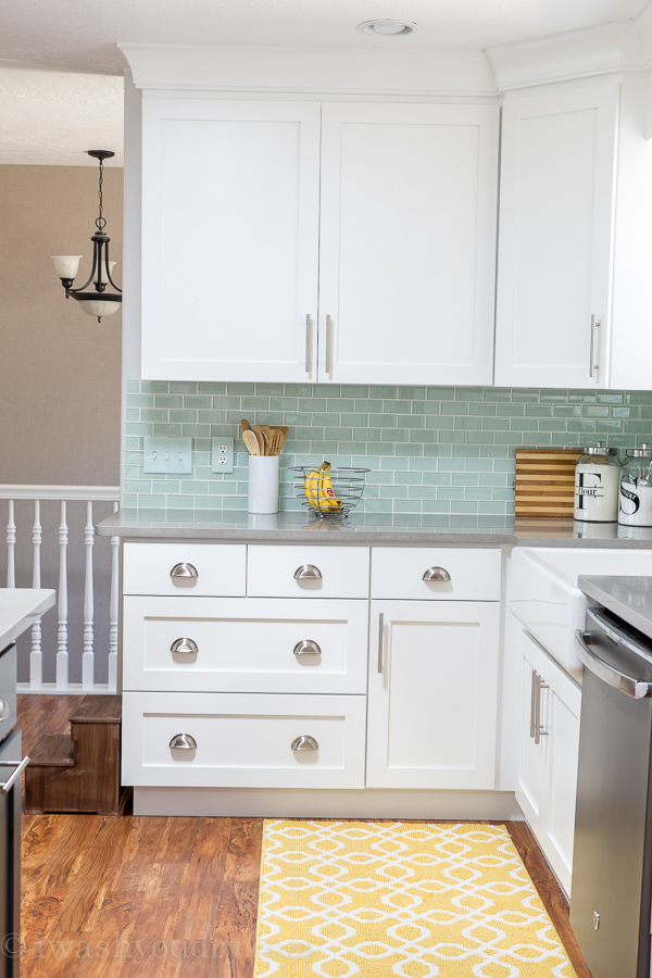 Kitchen Reveal - love this kitchen! Everything this blogger did, from new white shaker style cabinets to Quartz countertops that look like concrete and the gorgeous mint backsplash tiles. Stunning! 