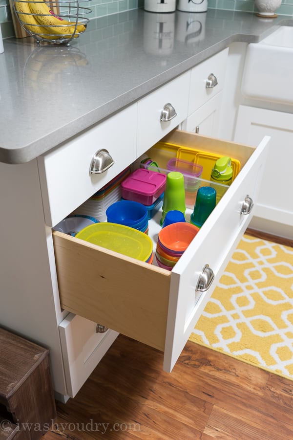 Use large pull out drawers to organize kids plates, bowls and cups so they can easily reach them.