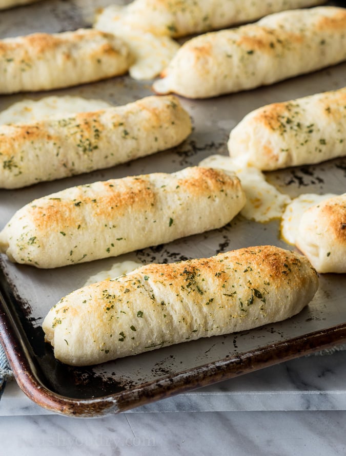 baked pizza sticks with cheese oozing out.