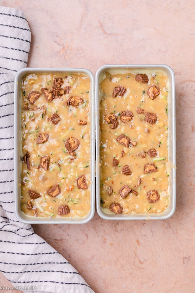 2 metal pans of raw zucchini bread batter. 