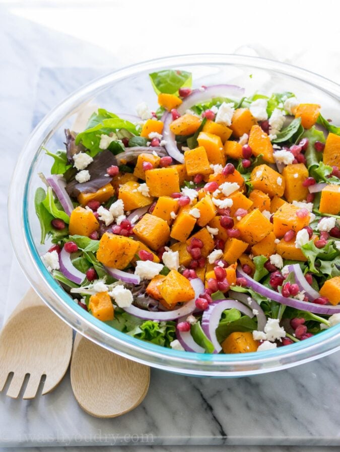 This super easy Butternut Squash Fall Salad is filled with pomegranate, feta cheese, purple onion and roasted butternut squash! It's such a great salad recipe to have on hand! 