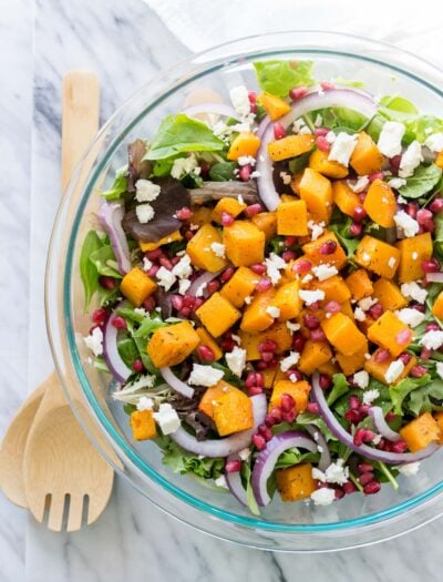 This super easy Butternut Squash Fall Salad is filled with pomegranate, feta cheese, purple onion and roasted butternut squash! It's such a great salad recipe to have on hand!