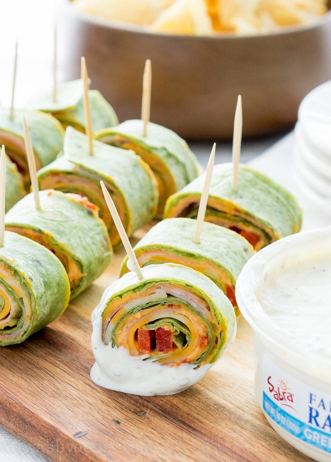 These Roasted Red Bell Pepper Hummus Pinwheels are full of so much flavor and are the perfect appetizer for any game day!