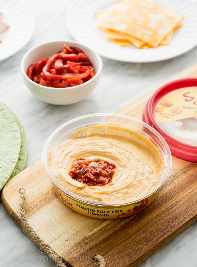 These Roasted Red Bell Pepper Hummus Pinwheels are full of so much flavor and are the perfect appetizer for any game day! 