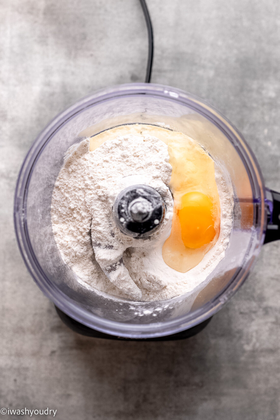 Flour, egg, and salt in food processor. 