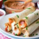 These Pizza Hummus Taquitos are a cheesy, crispy baked snack or appetizer that my kids go nuts for! They're so easy to make too!