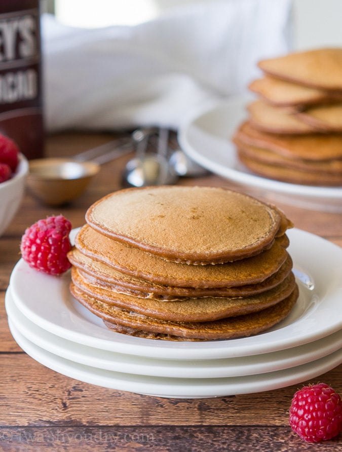 These Chocolate Pancakes are just a few simple ingredients and are made extra special with a scoop of vanilla ice cream and drizzle of chocolate syrup! 