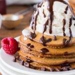 These Chocolate Pancakes are just a few simple ingredients and are made extra special with a scoop of vanilla ice cream and drizzle of chocolate syrup!