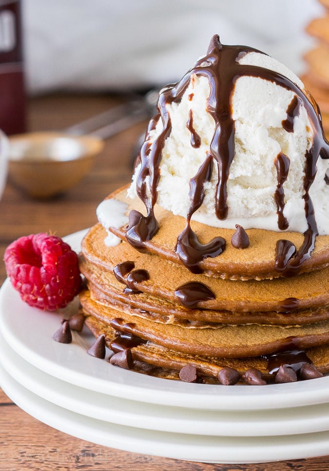 These Chocolate Pancakes are just a few simple ingredients and are made extra special with a scoop of vanilla ice cream and drizzle of chocolate syrup!