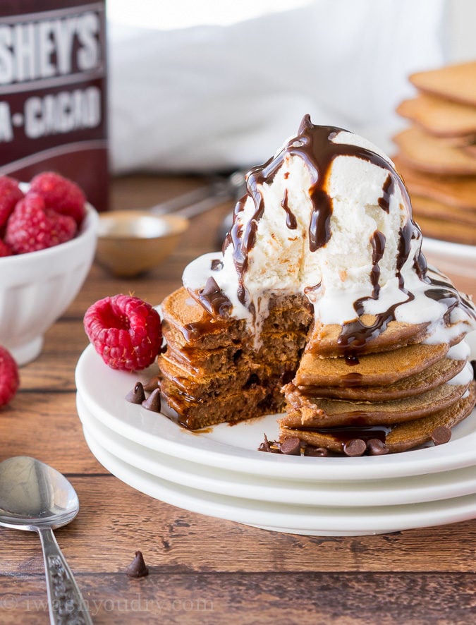 These Chocolate Pancakes are just a few simple ingredients and are made extra special with a scoop of vanilla ice cream and drizzle of chocolate syrup! 